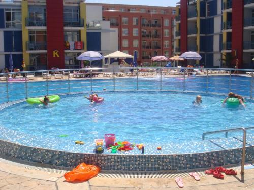 a large swimming pool with people in the water at Elit 4 Apartments in Sunny Beach