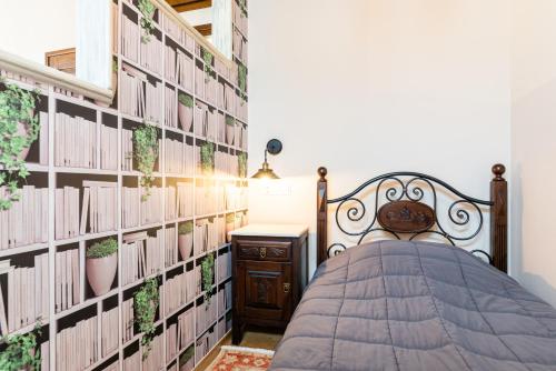 a bedroom with a bed and a wall of books at Kaza Guesthouse in Dhimitsana