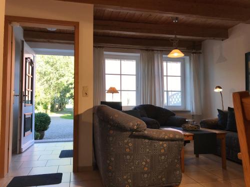 a living room with a couch and a table at Ferienhof Utech in Wenkendorf auf Fehmarn