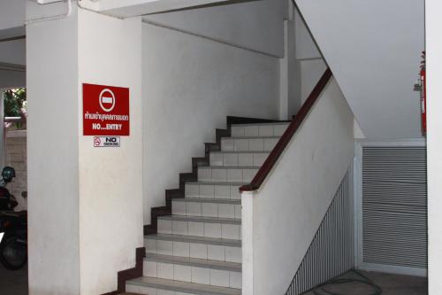a stairway with a sign on the side of a building at Soi 5 Apartment in Pattaya Central