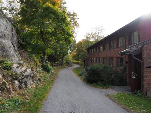 an empty road next to a brick building at Oscarsborg Castle Hotel & Resort in Drøbak