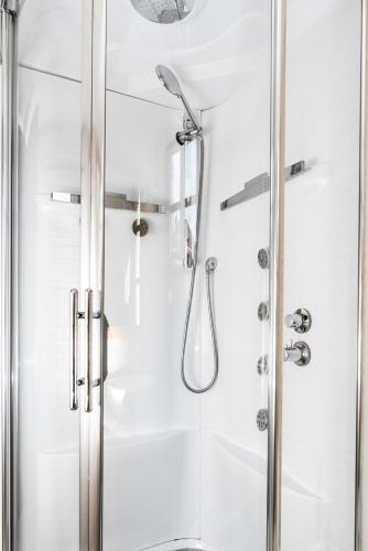 a shower with a glass door in a bathroom at Kaza Guesthouse in Dhimitsana