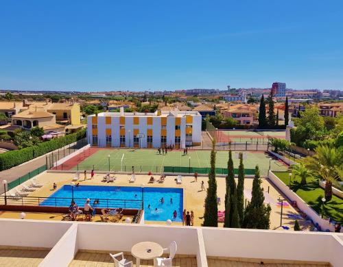 
a large building with a large pool of water at Rialgarve in Faro
