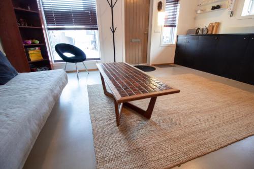 a living room with a coffee table and a couch at Central Reykjavík - Garden Cottage in Reykjavík