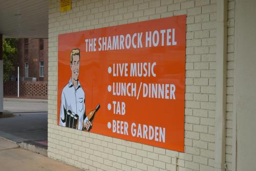 an orange sign on the side of a building at The Shamrock Hotel Balranald in Balranald