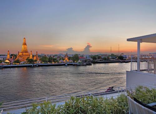 a view of a river with a city in the background at Sala Rattanakosin Bangkok in Bangkok