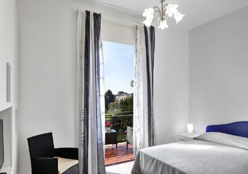 a bedroom with a bed and a view of a balcony at Stella House in SantʼAgata sui Due Golfi