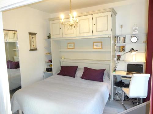 une chambre avec un lit, un bureau et un ordinateur dans l'établissement LES GRANDS CEDRES C1 7 Avenue de Fabron, à Nice