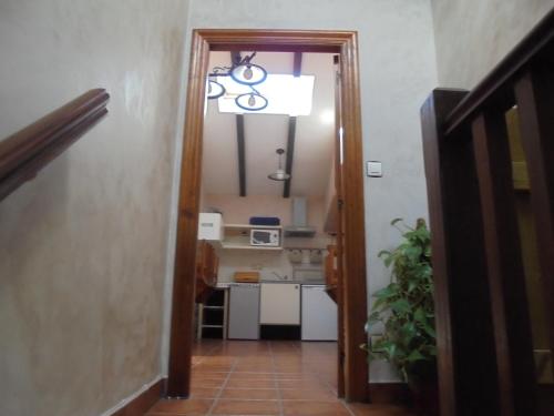a hallway with a room with a kitchen and a light at Albergue Areitz Soroa in Arce