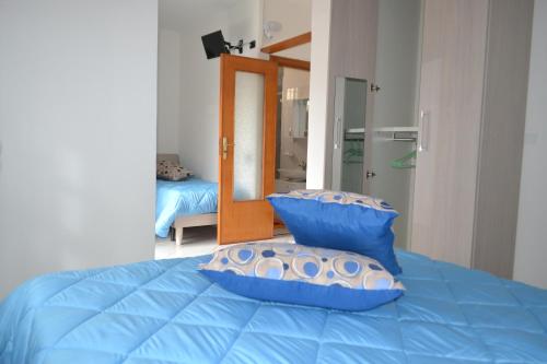 a blue bed with two pillows on top of it at B&B Casa Di Lauro in Trecase