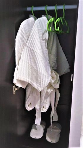 a rack of white towels and slippers in a closet at Greenery Resort Koh Tao in Koh Tao