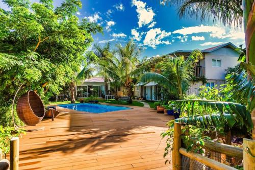 a backyard with a pool and trees and a house at Rusty Pelican - "Goofy Gecko" Container Apt. in La Gaulette