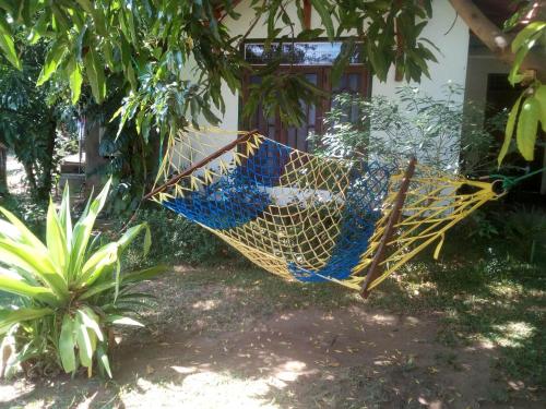 a hammock hanging from a tree in front of a house at Bangalawa Resort in Habarana