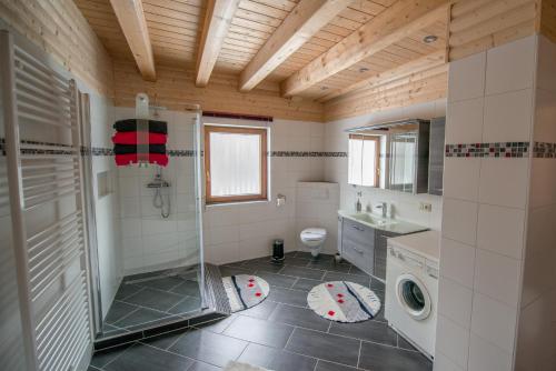 a bathroom with a shower and a washing machine at Betzemühle 2 Bauernhof in Altenschlirf