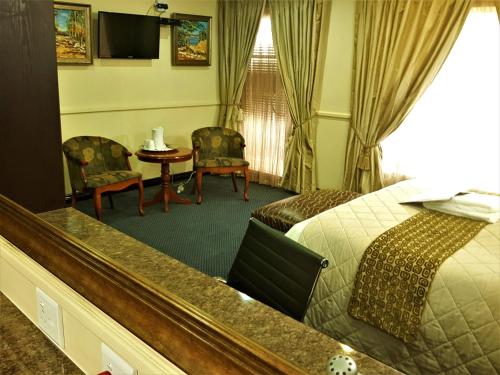 Katil atau katil-katil dalam bilik di Constantia Manor Guest House