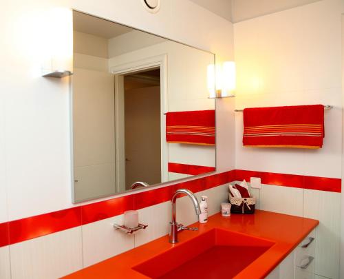 a bathroom with a red sink and a mirror at The Villa of the Winds in Néa Kíos