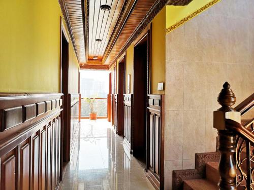 a hallway with stairs in a building with yellow walls at Okay Palace Hotel in Phnom Penh