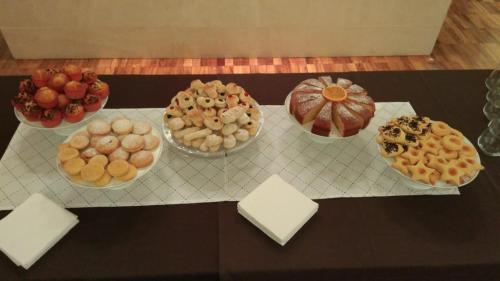 a table with many different types of pastries on it at Torrione Hotel in Reggio Calabria