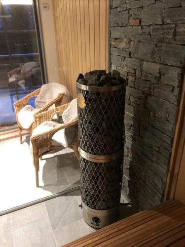 a trash can in front of a stone fireplace at Fjällhem in Sälen