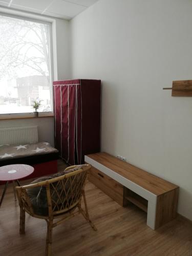 a living room with a bench and a window at Ubytovanie Queen in Nováky