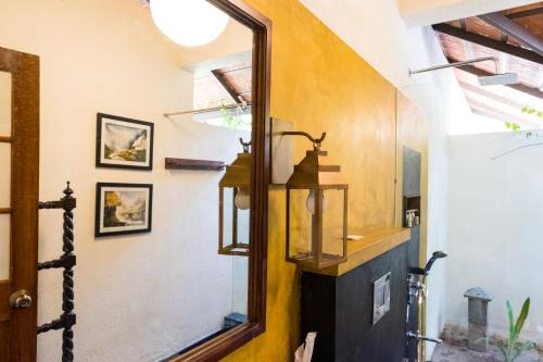 a bathroom with a mirror and a sink at Cranganor History Café & Riverside Château in Parūr