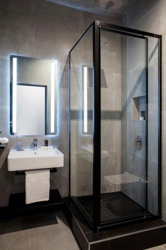 a bathroom with a shower and a sink at The Capital Melrose in Johannesburg
