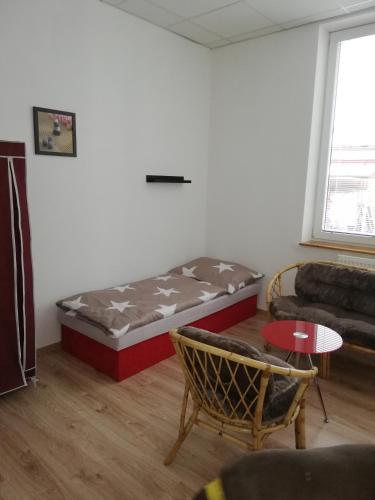 a living room with a bed and a couch at Ubytovanie Queen in Nováky