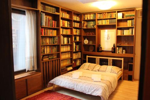 a bedroom with a bed in a room with bookshelves at Chalet Heidi BKK in Bad Kleinkirchheim