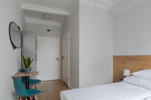 a bedroom with a bed and a table and chairs at MoHo XL in Wrocław