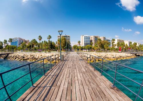 a wooden boardwalk over the water in a city at Limassol Old Town Mansion in Limassol