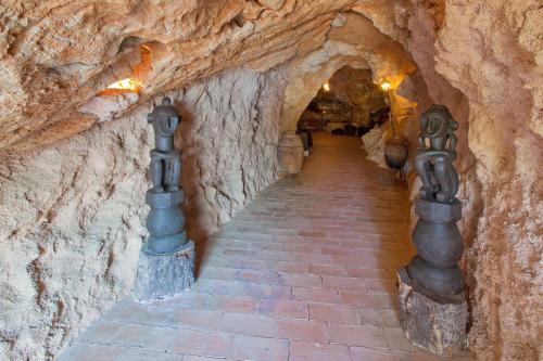 a tunnel in a cave with a stone wall at Hotel Punta Est in Finale Ligure