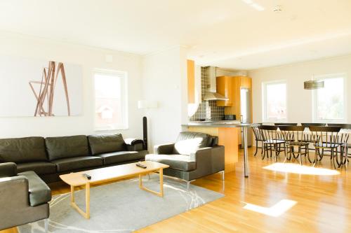 a living room with a couch and a table at Vidbynäs Gård & Konferens in Nykvarn