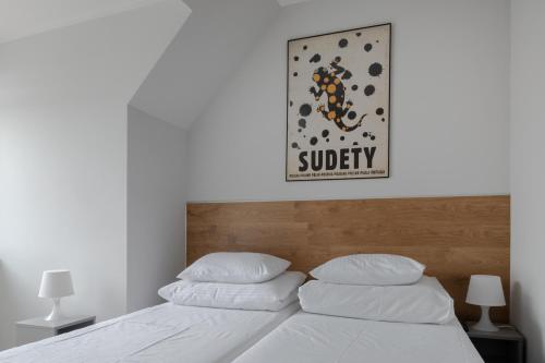 a bed with two pillows and a sign that reads subway at MoHo XL in Wrocław