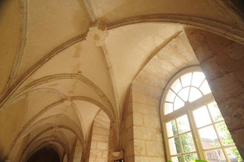 a room with a large window in a building at Hôtellerie Saint Yves in Chartres