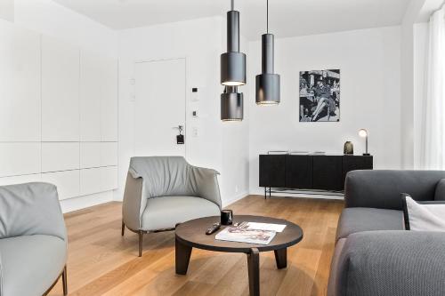 a living room with two chairs and a coffee table at STAY Bryggen in Copenhagen