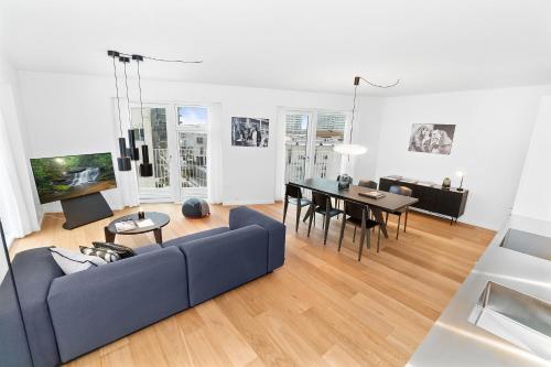 a living room with a couch and a table at STAY Bryggen in Copenhagen