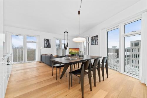 a dining room and living room with a table and chairs at STAY Bryggen in Copenhagen