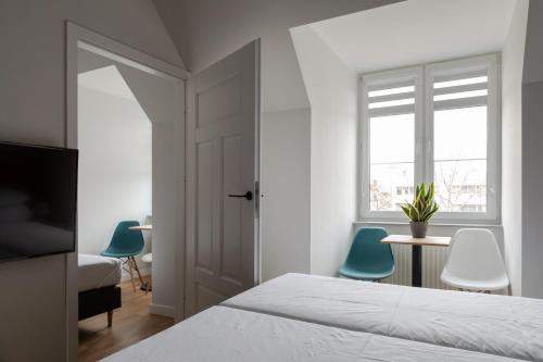 a bedroom with a bed and two blue chairs at MoHo XL in Wrocław