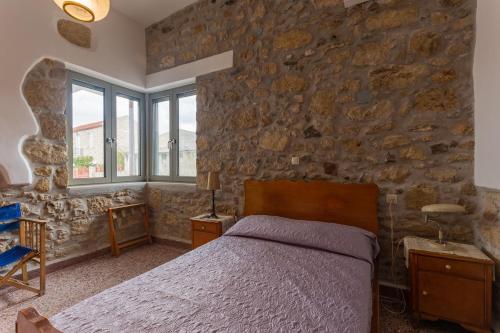 A bed or beds in a room at Iliopetra House