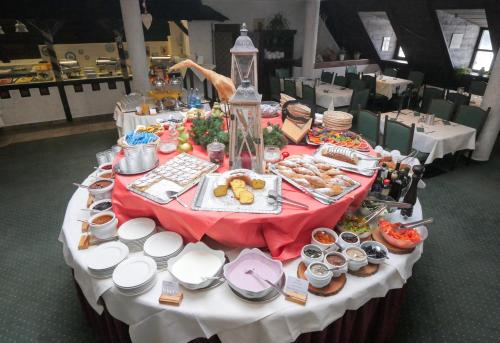 a table filled with food on top at Family Hotel Schloss Rosenegg in Fieberbrunn