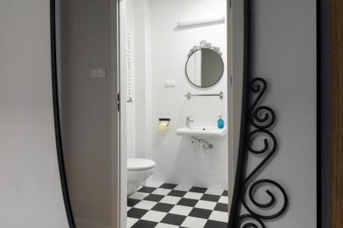 a bathroom with a toilet and a sink and a mirror at MoHo XL in Wrocław