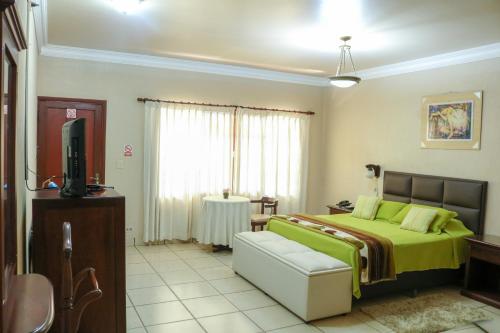 מיטה או מיטות בחדר ב-HOTEL BOUTIQUE EL RANCHO OLIVO
