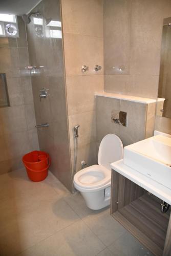 een badkamer met een toilet, een douche en een wastafel bij Hotel Bhimas Paradise in Tirupati