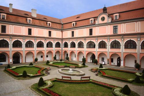 a large building with a courtyard with a fountain at Zámecký Penzion in Valašské Meziříčí