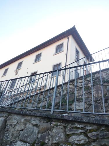 a house on top of a stone wall at Rocca Palazzaccio in Impruneta