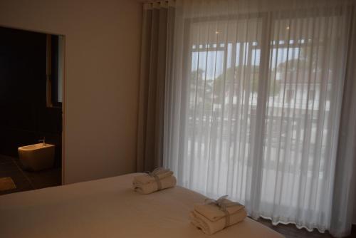 a bedroom with a bed with two boxes on it at Villa Alcova in Caorle