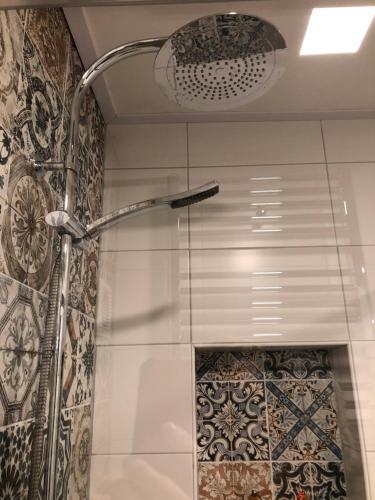 a shower with a shower head in a bathroom at Silly's Inn in Middelburg