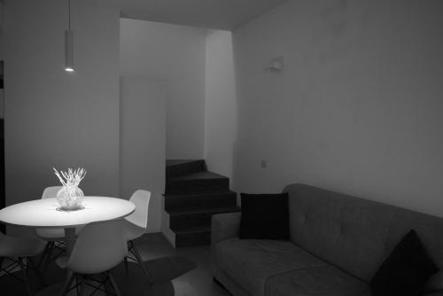 a living room with a couch and a table and stairs at Villa Alcova in Caorle