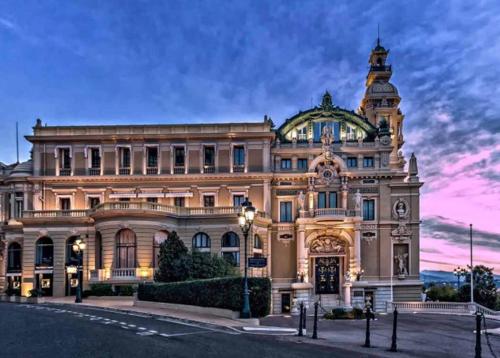 a large building with a clock tower on top of it at Chambre Love Luxe Monaco in Beausoleil