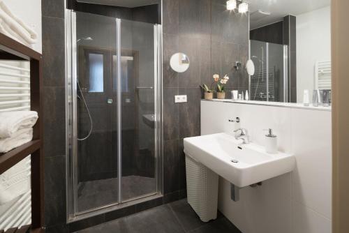 a bathroom with a sink and a shower at RAFAEL KAISER - Premium Apartments - Contactless Check-In in Vienna